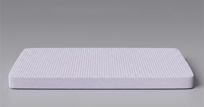 Mattress topper with a textured surface on a gray background